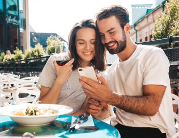 Smiling beautiful woman and her date at their date in a restaurant