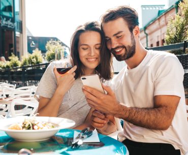 Smiling beautiful woman and her date at their date in a restaurant