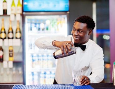 A bartender mixing drinks at a bar