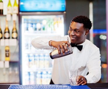 A bartender mixing drinks at a bar