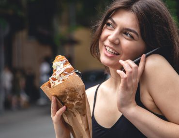 Young woman with a croissant and a cup of coffee