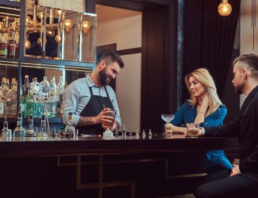 Bartender serving an attractive couple on an evening date