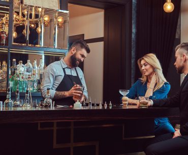 Bartender serving an attractive couple on an evening date