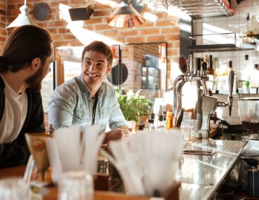 Male friends having drinks at a bar