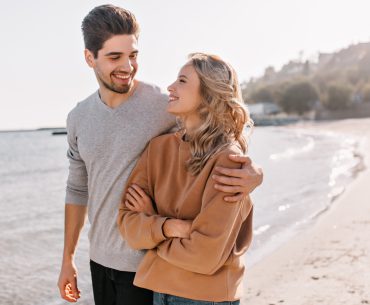 Young couple walking by the beach