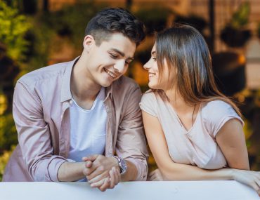 Young couple smiling at each other