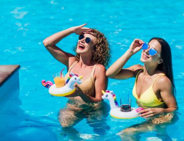 Two beautiful girls in swimsuits in the pool