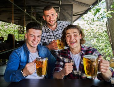 Three singles drinking beer in pub