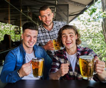 Three singles drinking beer in pub
