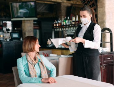 Woman being served in a cafe