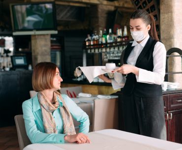 Woman being served in a cafe