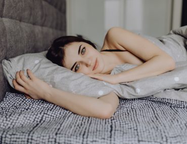 Beautiful young woman lying on the sofa