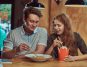 Young man and woman on a date and eating spicy noodles in a Dallas restaurant