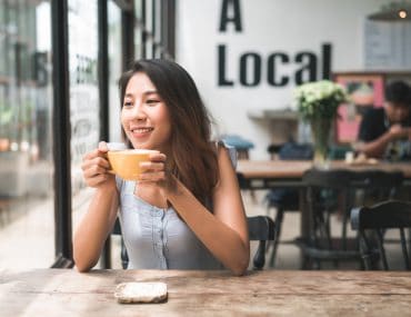 Young woman drinking coffee in a cafe