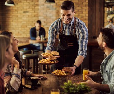 Green Bay Hookup | Where to Pick Up and Date Girls in Green Bay A waiter serving food to a couple on a date