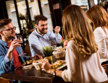 Young people having a double dinner date at a restaurant