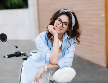 Smiling single girl sitting on a motorcycle
