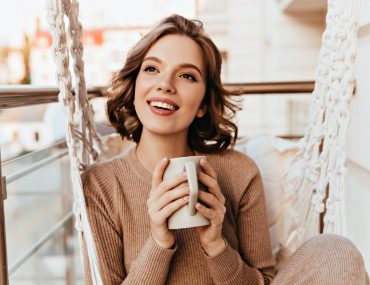 A young woman drinking a cup of tea