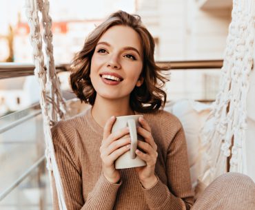 A young woman drinking a cup of tea