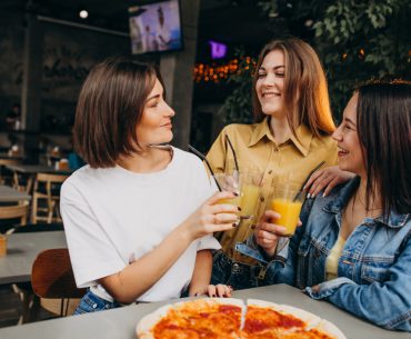 Lancaster Hookup | Where to Date and Pick Up Girls in Lancaster girl friends having pizza at a bar at a lunch time