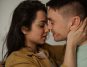 Woman leaning in to kiss a man