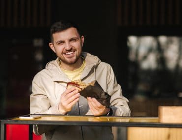 Young man eating a hotdog