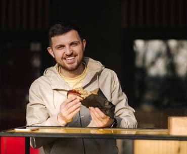 Young man eating a hotdog