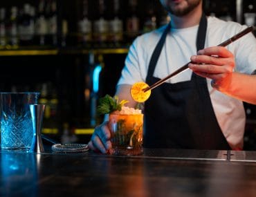 A bartender mixing a cocktail