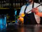 A bartender mixing a cocktail