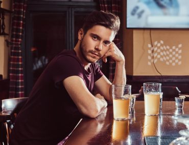 Handsome young man sitting at a bar counter
