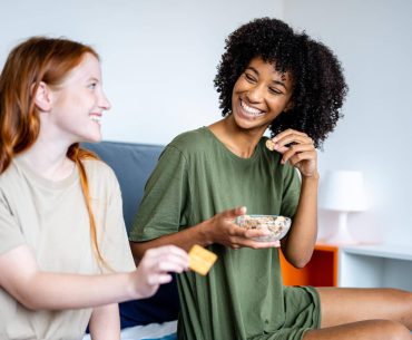 Couple of gay woman having breakfast together at bed