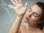 Sensual young woman captured through wet glass