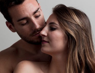 Naked couple kissing each other
