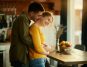 A man embracing his partner in their home