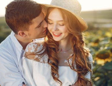 Stylish couple in a sunflower field