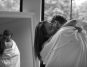 Side view of a couple hugging with a bedsheet over them