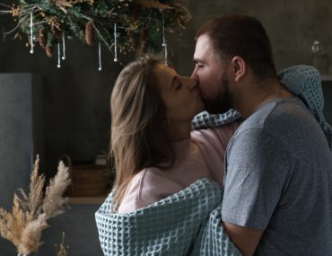 Woman and man making out in a room