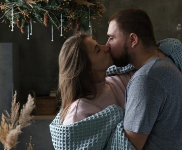 Woman and man making out in a room
