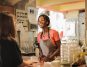 Female bartender attending to a customer at the counter